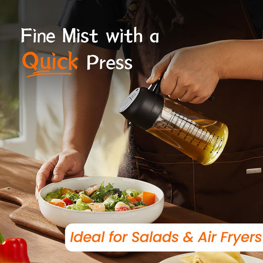 TrendPlain 470ml 2-in-1 oil spray bottle demonstrating a fine mist with a quick press while seasoning a fresh green salad