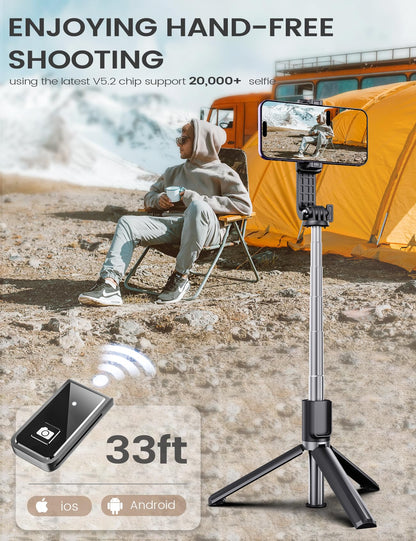 ANXRE extendable selfie stick and tripod lifestyle photo showing a person using the 33ft wireless remote control for hands-free group shooting outdoors with an orange tent background