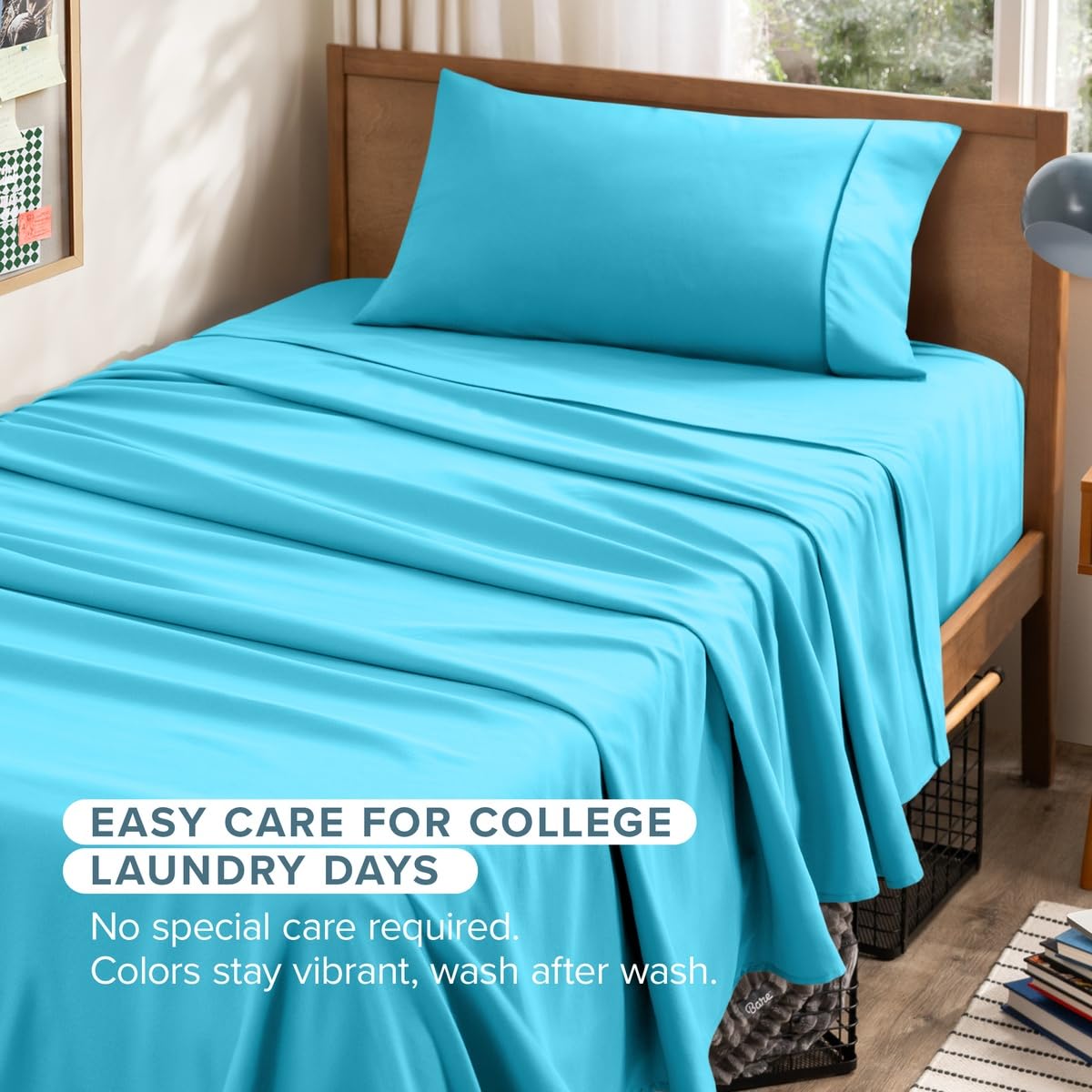 Bright turquoise blue bedding set including a fitted sheet and matching pillowcase on a wooden bed frame in a bedroom setting, with promotional text overlay at the bottom about easy care for college laundry days.