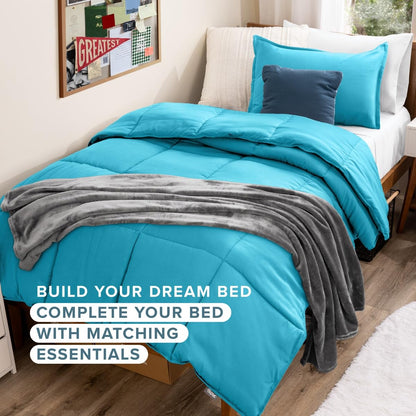 A made bed in a bedroom setting with bright turquoise bedding, including a comforter, matching pillow shams, and a dark blue accent pillow, with a gray plush throw blanket draped across the foot of the bed.