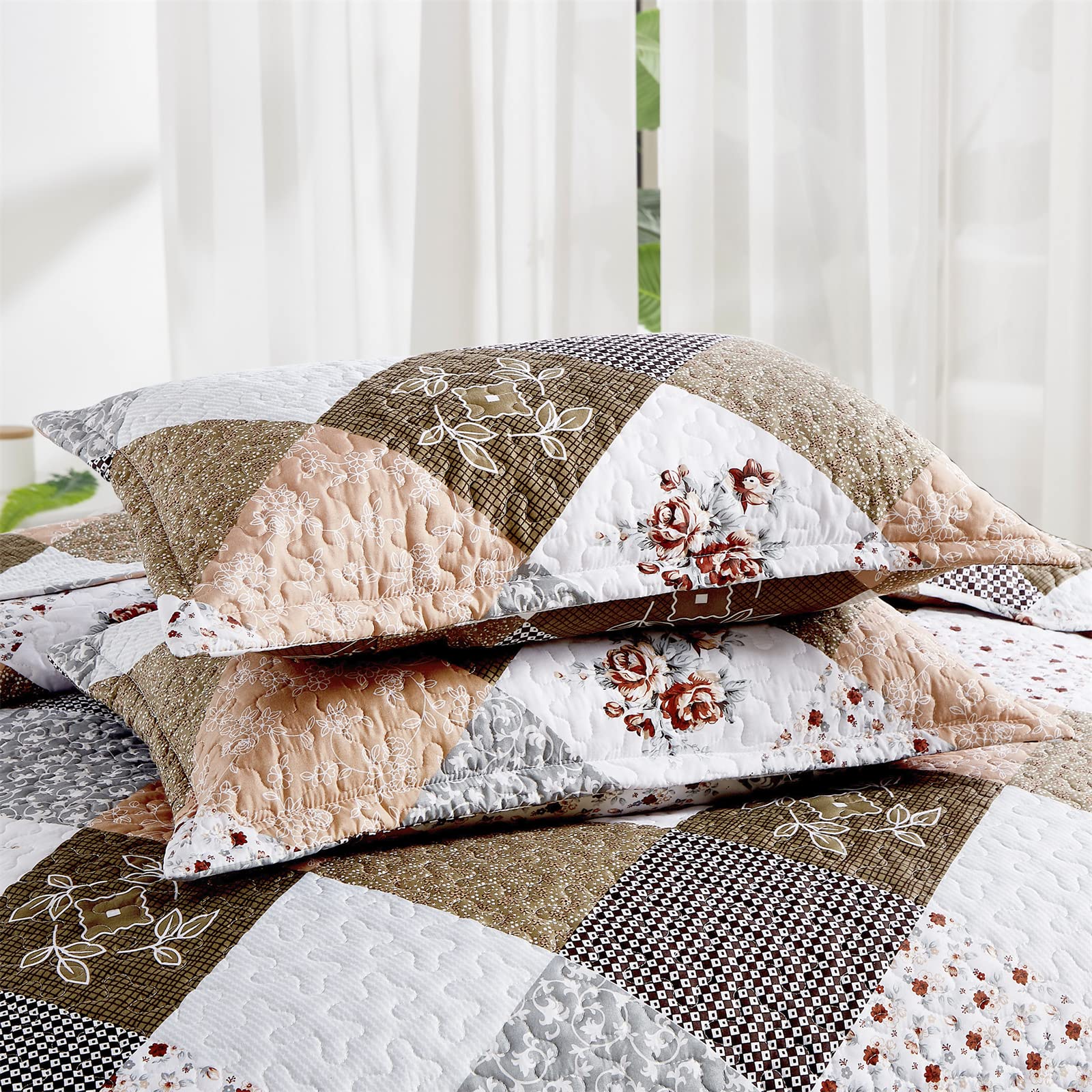 Close-up of two matching pillowshams with floral patchwork pattern and scalloped edges from the Dinjoy Quilt Bedding Set