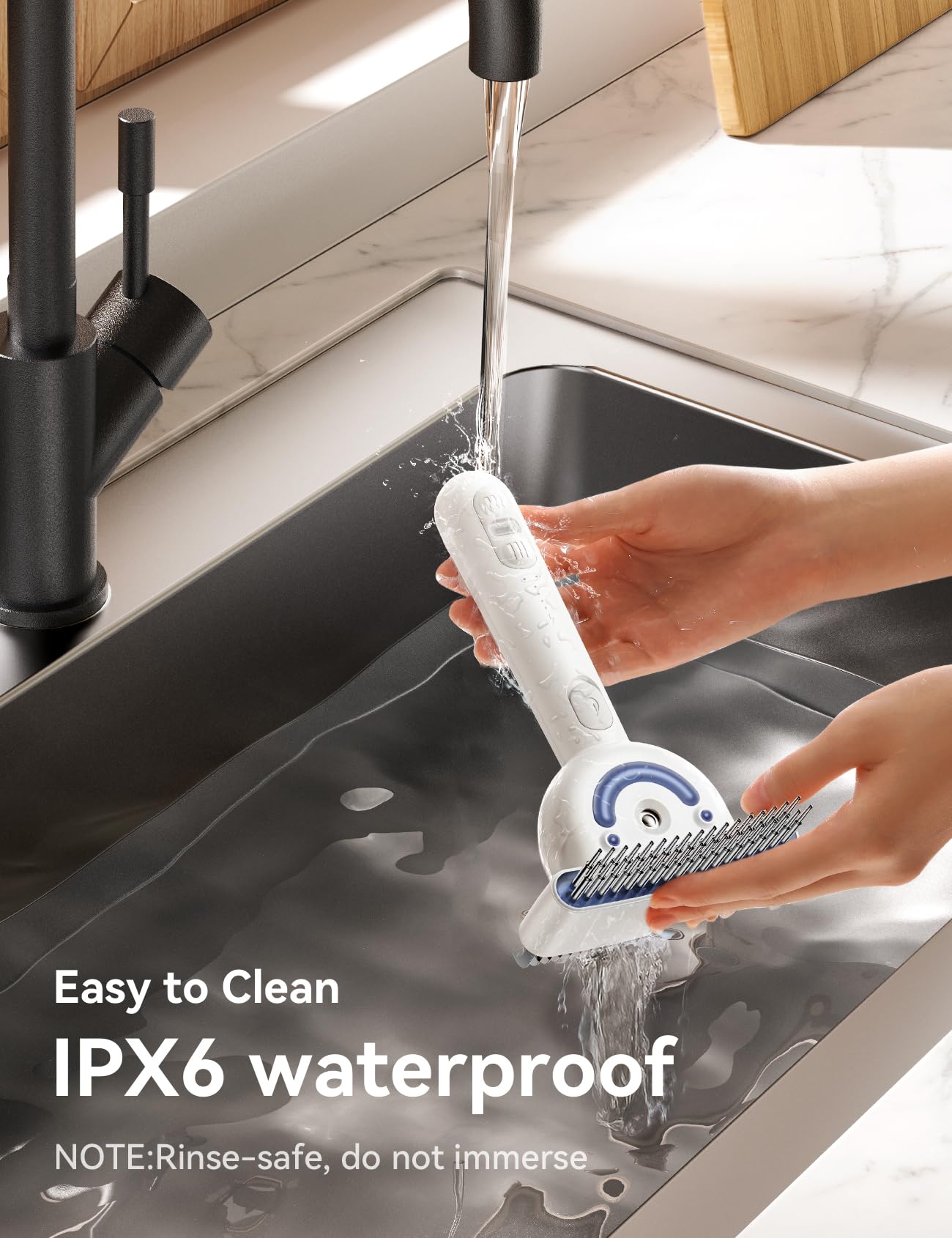 Close-up of hands rinsing the FEELNEEDY Dual-Sided Pet Steam Brush under a kitchen sink faucet, highlighting its IPX6 waterproof, rinse-safe design.