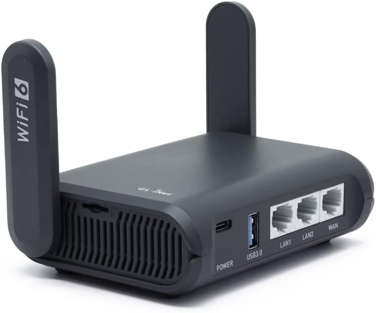 Black GL.iNet Slate AX Wi-Fi 6 travel router showing dual antennas and Ethernet ports on a white background