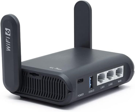 Black GL.iNet Slate AX Wi-Fi 6 travel router showing dual antennas and Ethernet ports on a white background