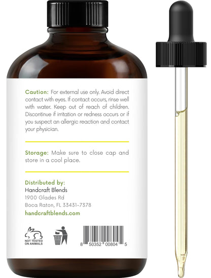 Back label of Handcraft Blends Lemon Essential Oil in an amber glass bottle displaying safety cautions, storage instructions, and distributor details. A glass dropper is placed alongside.