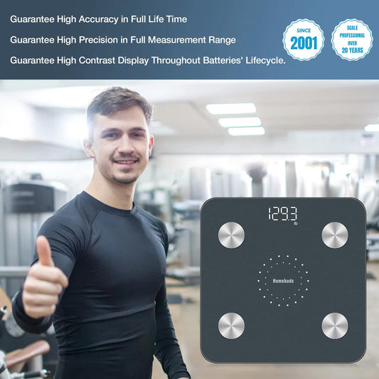 Man giving a thumbs up next to a digital body fat scale in a gym setting