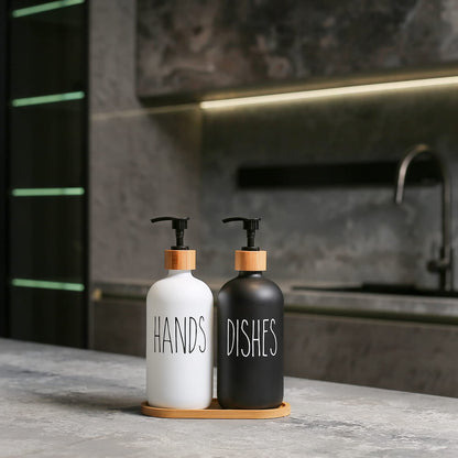 Two soap dispensers labeled 'HANDS' and 'DISHES' on a kitchen counter.