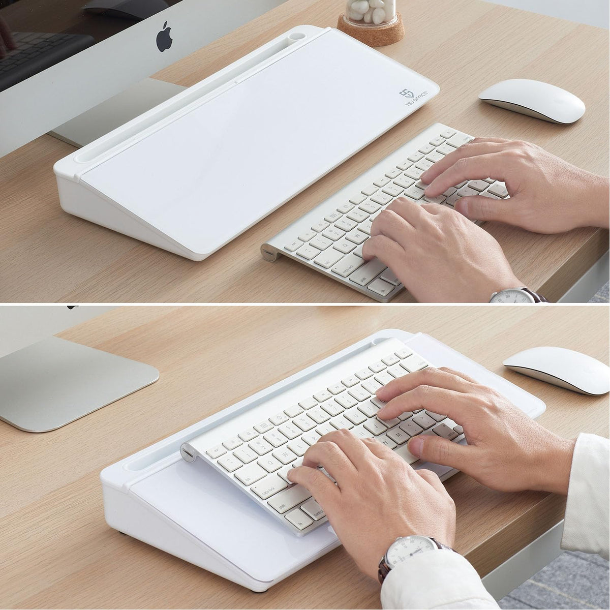 Person using a keyboard on a wooden desk with a computer monitor and mouse.