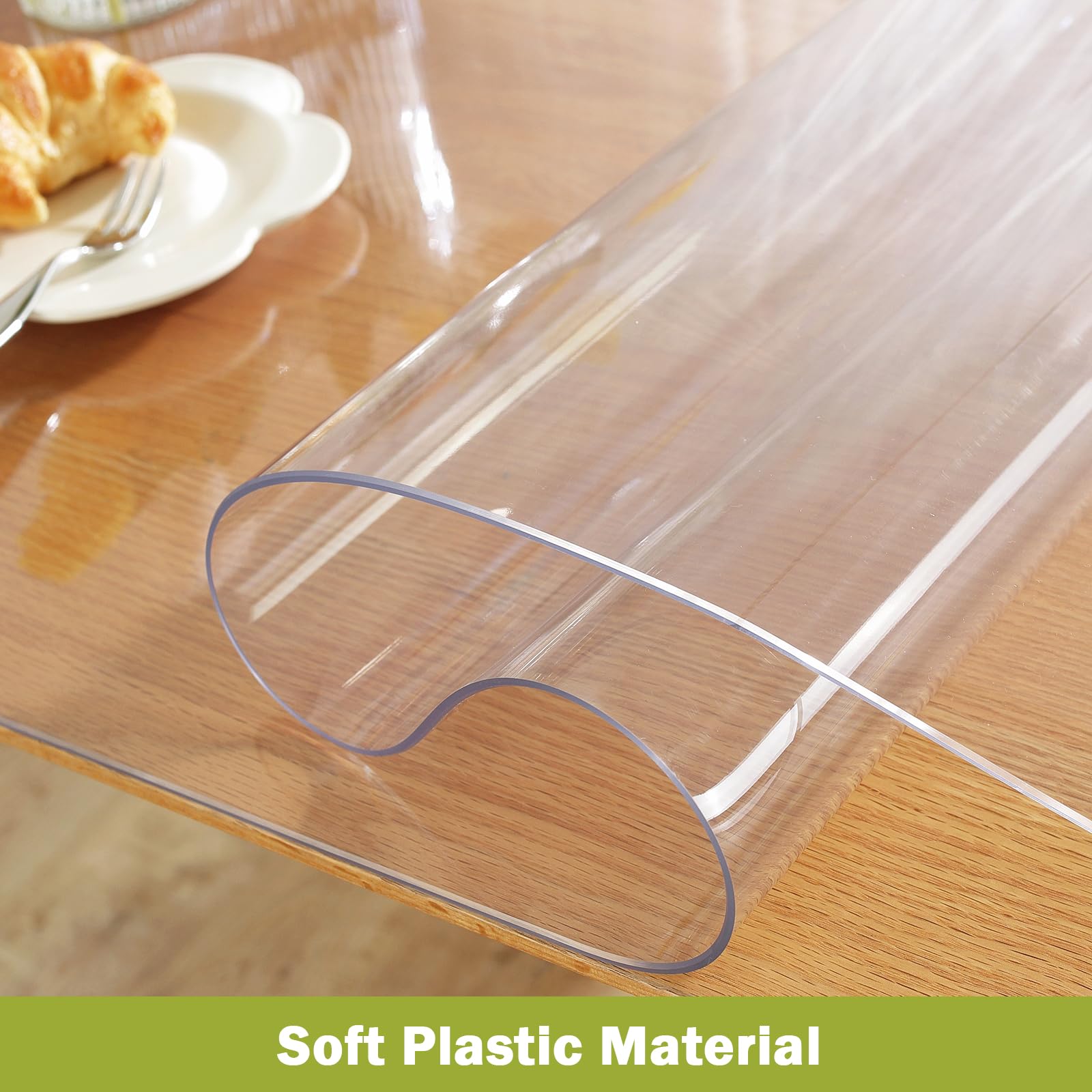 OstepDecor Clear Table Protector unrolled on a wooden table, highlighting the flexible and soft plastic material with text overlay 'Soft Plastic Material'.