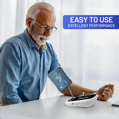 Older man sitting at a table using the REDIVN upper arm blood pressure monitor, with text overlay reading 'Easy to use, excellent performance'.