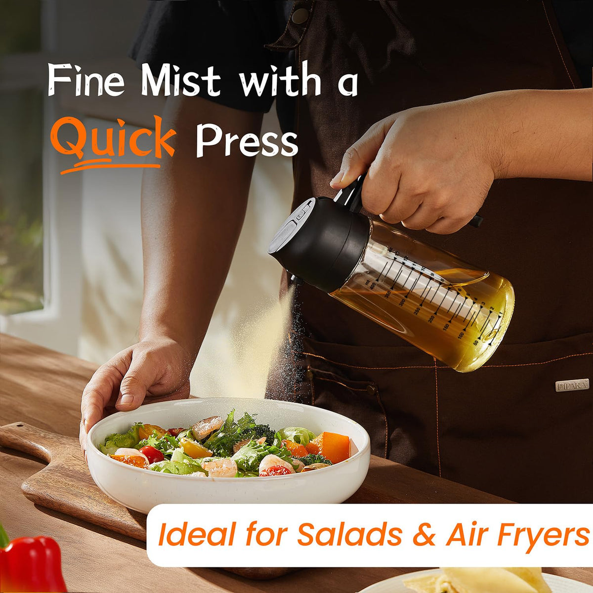 TrendPlain 470ml 2-in-1 oil spray bottle demonstrating a fine mist with a quick press while seasoning a fresh green salad